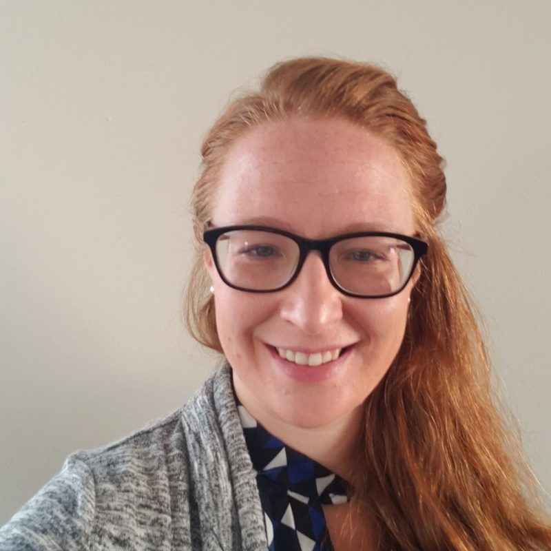 Dr. Jennifer Gamracy, BVMS, Cardiology Resident, smiling while wearing glasses and a grey cardigan over a patterned shirt, photographed against a neutral background.