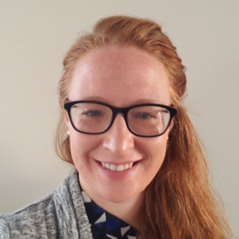 Dr. Jennifer Gamracy, BVMS, Cardiology Resident, smiling while wearing glasses and a grey cardigan over a patterned shirt, photographed against a neutral background.