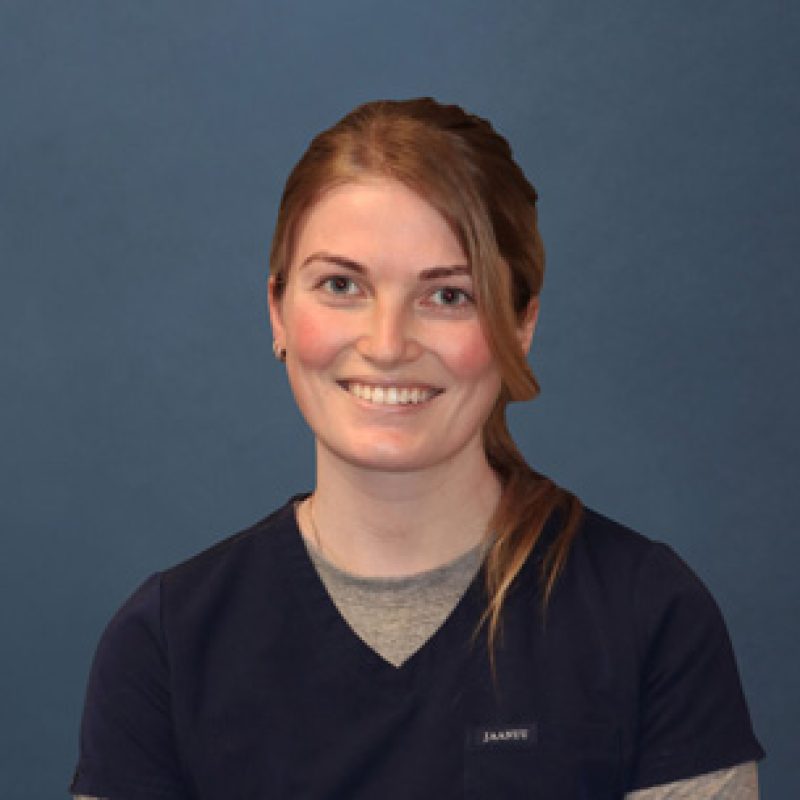 Dr. Sara McNamara, Emergency Veterinarian (Locum) at Boundary Bay Veterinary Specialty Hospital, smiling in navy scrubs